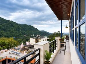 a balcony with a view of the mountains at Hotel Weekend Heights in Rishīkesh +71 photos