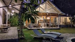 a patio with chairs and a house at night at Sun Moon Star Villas in Jarakan