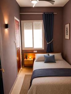 a bedroom with a large bed and a window at Parascheva St Jordi in Tossa de Mar +8 photos