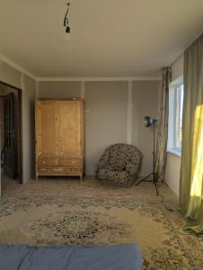 a bedroom with a bed and a dresser and a chair at Meikin guest house in Chok-Tal
