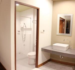 a bathroom with a shower and a toilet and a sink at Phumin Place Hotel in Nan