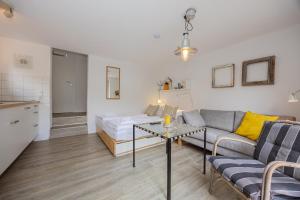 a living room with a couch and a table at Stabenweg Whg. 1 in Göhren