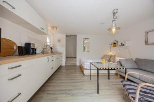 a kitchen and living room with a couch and a table at Stabenweg Whg. 1 in Göhren
