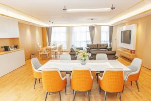a living room with a table and chairs at 玉恒酒店 in Sihui