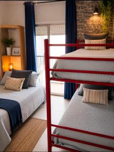 two bunk beds in a room with a window at Parascheva St Jordi in Tossa de Mar