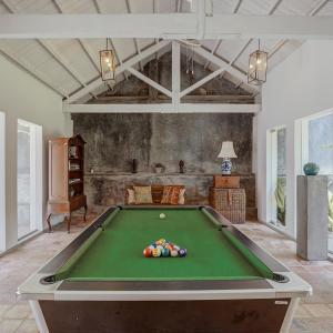 a pool table in a living room with a pool table at Villa Republic River View Bentota in Aluthgama