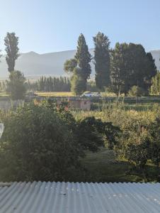 a view of a field with trees and a building at Meikin guest house in Chok-Tal