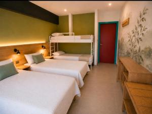 a bedroom with two bunk beds and a red door at Parascheva St Jordi in Tossa de Mar