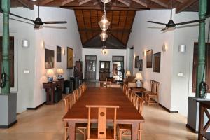 a dining room with a long table and chairs at Villa Republic River View Bentota in Aluthgama +73 photos