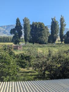 a view of a field with trees and a bench at Meikin guest house in Chok-Tal
