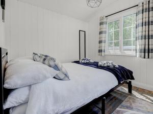 a bedroom with a bed with pillows and a window at Hoy Haven in Whitwell +10 photos