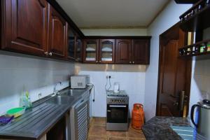 a kitchen with a sink and a stove at MakerereViewAirbnb in Kampala +11 photos