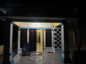 a hallway of a house with a blue chair at Bahruksi HomeStay in Huta Baju