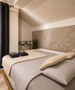 a bedroom with a bed with two towels on it at Casa Cordis in Korduševci +115 photos