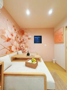a living room with a flower mural on the wall at 刻宿Toki Stay Ueno in Tokyo