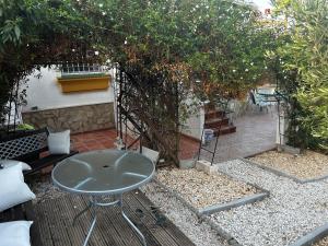 a table and chairs on a patio with trees at Villa Carmen in Torrox Costa +21 photos