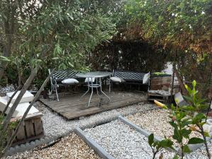 a wooden deck with chairs and a table in a garden at Villa Carmen in Torrox Costa