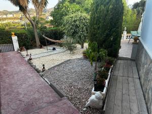 a garden with a wooden walkway and some plants at Villa Carmen in Torrox Costa