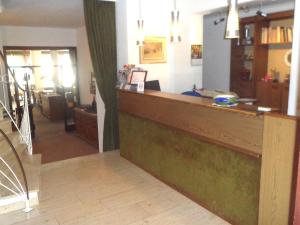 a bar in a room with a living room at Hotel Schneider in Bad Säckingen