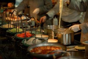 a group of people in a kitchen preparing food at Shigatse Summer Palace Healing Hotel in Shigatse