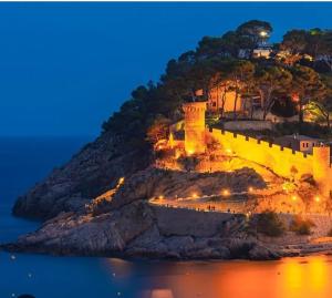 a castle on a hill with lights on it at Parascheva St Jordi in Tossa de Mar