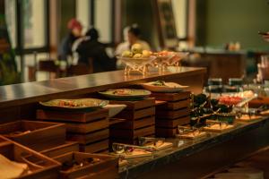 a buffet line with plates of food on display at Shigatse Summer Palace Healing Hotel in Shigatse