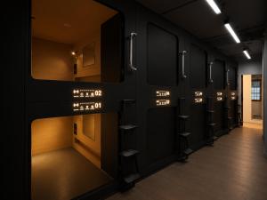 a dressing room with a row of mirrors at OWNLY CAPSULE Hotel in Bangkok