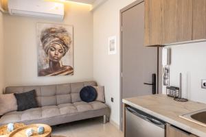 a living room with a couch and a painting on the wall at Baja Suites in Kalamata