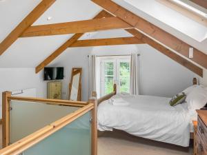 a bedroom with a bed in a attic at Coach House in Holsworthy