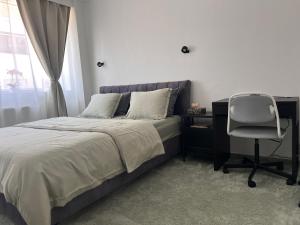 a bedroom with a bed and a desk and a chair at Modern private Rooms with attached Bathroom & Free Parking in Bruges