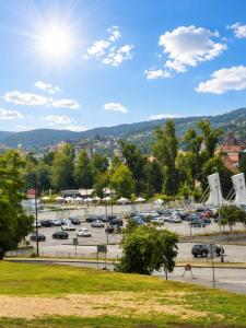 a parking lot with cars parked in a parking lot at Salt Oasis Apartment Tuzla in Tuzla