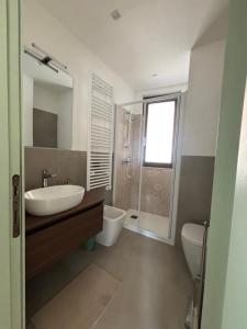 a bathroom with a sink and a toilet and a shower at Sotto il castello in Borno