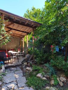 a patio with a table and chairs under a wooden pergola at Дом у моря с бассейном и сауной in Odesa