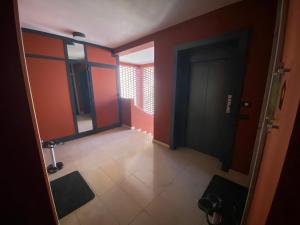 an empty hallway with red walls and a door at Residence Le Volte Apartments in Parma +80 photos