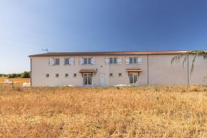 a large white building in the middle of a field at Duplex N°6 - Résidence Balnéaire in Le Port-des-Barques