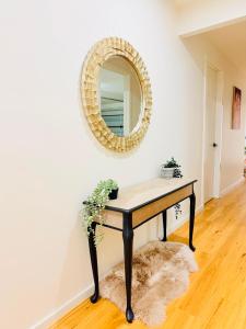 a table with a mirror on a wall at Serenity Suite with Private Bathroom in Wyndham Vale