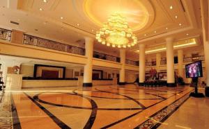 a large lobby with a chandelier and a large hall at Datong Hotel in Datong