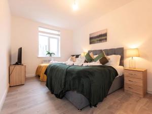 a bedroom with a large bed and a television at Flat 1-Uk41147 in Southampton