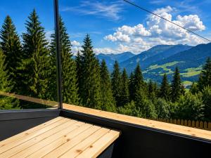 a room with a balcony with a view of the mountains at Chalet in Hopfgarten in Hopfgarten im Brixental