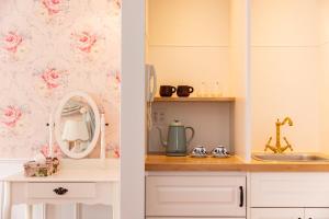 two views of a kitchen with pink roses wallpaper at WhiteRunse in Takayama +23 photos