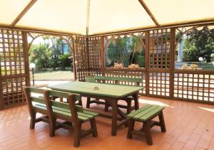 a gazebo with a table and benches in it at B&B Villa Maya in Termoli