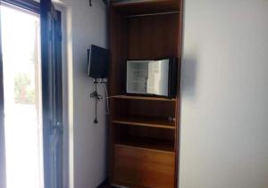 a television sitting on a wooden shelf in a room at B&B Villa Maya in Termoli