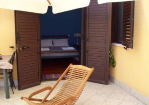 a patio with a chair and a bed in a room at B&B Villa Maya in Termoli