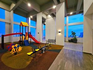 a room with a playground with a slide at 2BR Infinity Pool Condo Near Jonker 5Pax in Malacca