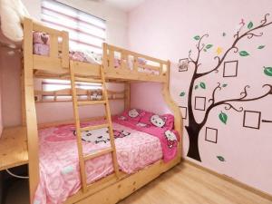 a bedroom with bunk beds with a tree mural at 2BR Infinity Pool Condo Near Jonker 5Pax in Malacca +14 photos