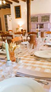 a table with a checkered table cloth on it at Logis Hôtel Auberge de la Hulotte in Saint-Jacques-dʼAmbur +19 photos