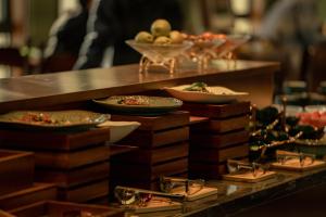 a buffet with plates of food and bowls of fruit at Shigatse Summer Palace Healing Hotel in Shigatse
