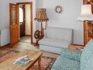 a living room with a couch and a table at Weaver's Cottage in Banchory
