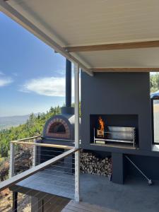 a patio with a fireplace and a fire pit at untether on Olive View in Wellington