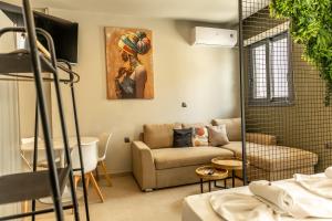 a living room with a couch and a table at Baja Suites in Kalamata